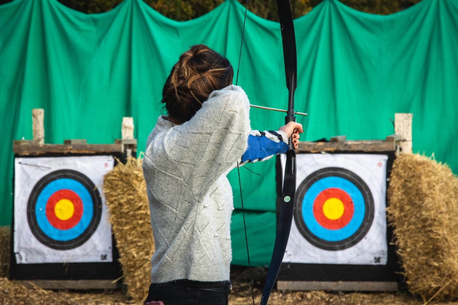 A Mother enjoying a winter archery session with her family.