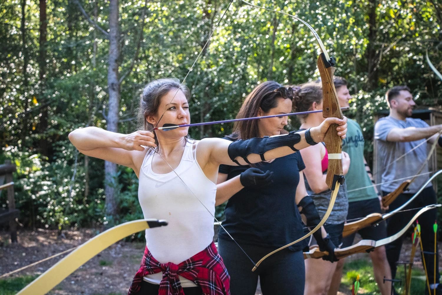 A group of colleagues taking part in archery during a themed package day