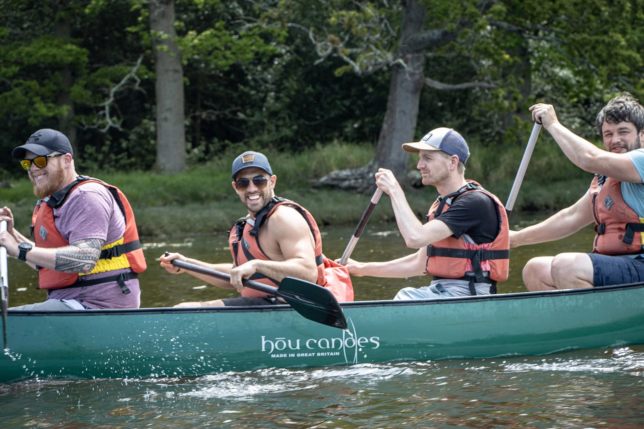 Four mates enjoying a Stag party canoeing on the Beaulieu River