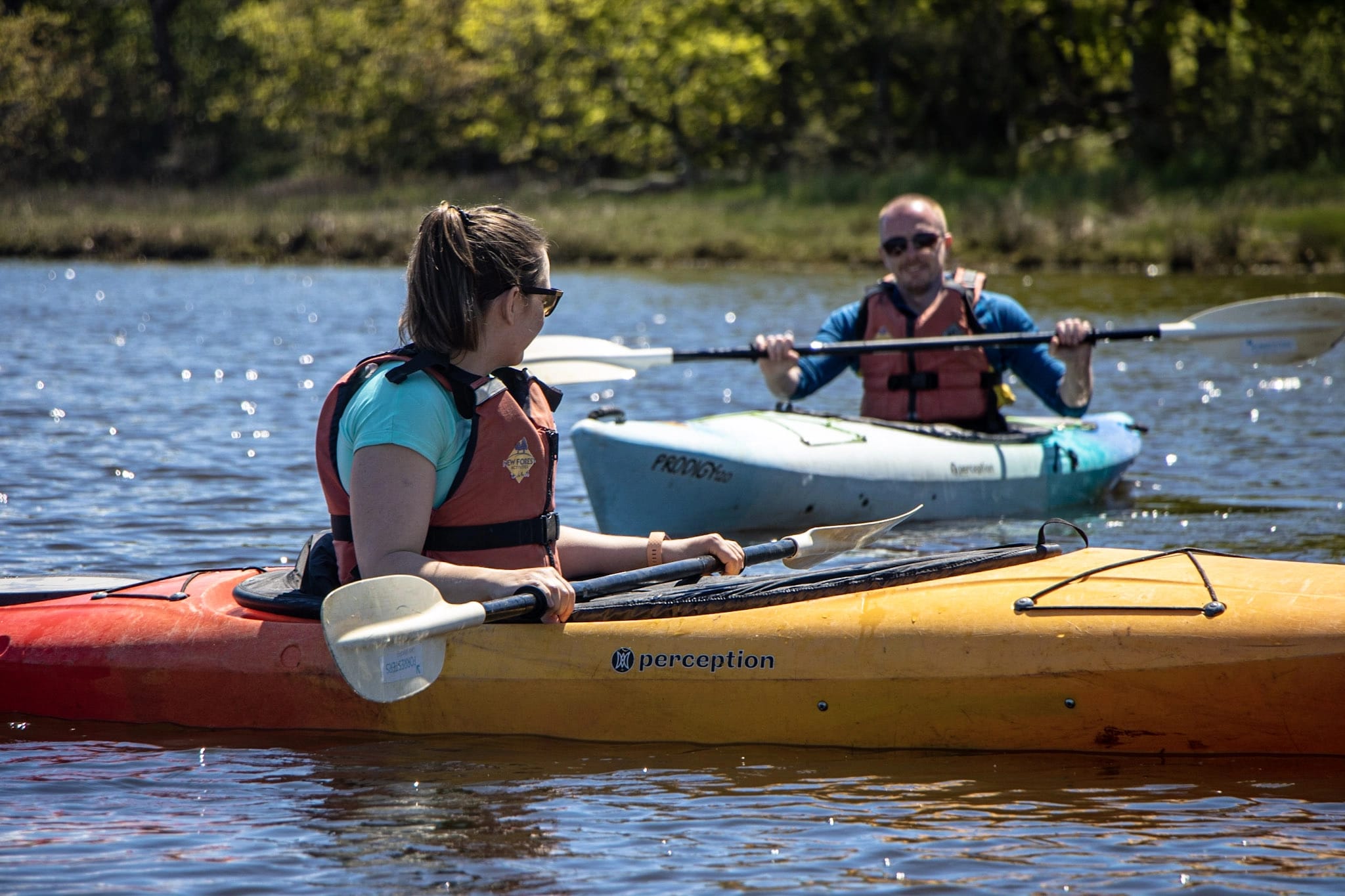 A couple enjoying a guided kayaking tour on the Beaulieu River.