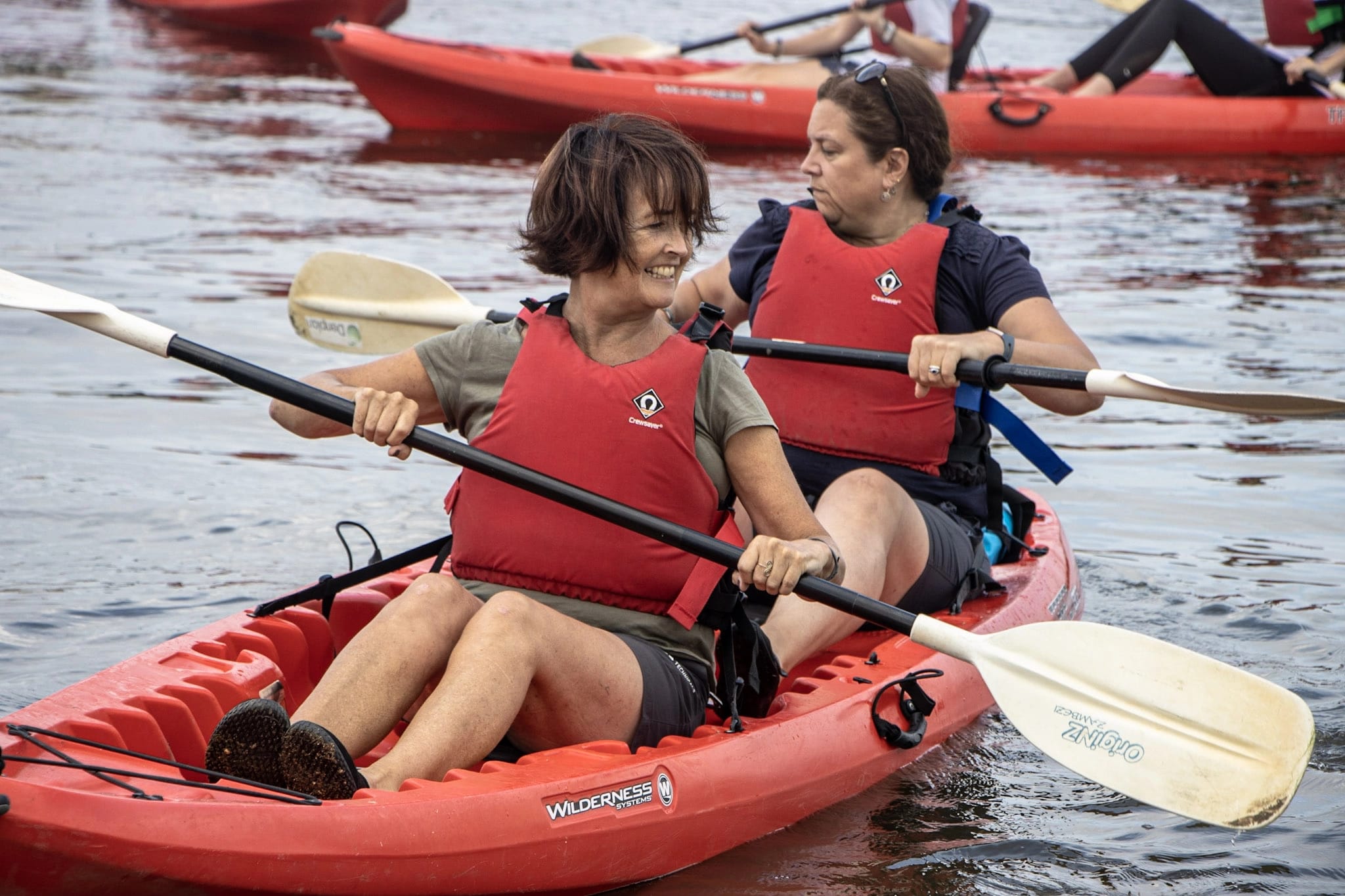 two female friends enjoying kayak hire after looking for fun activities for adults in The New Forest.