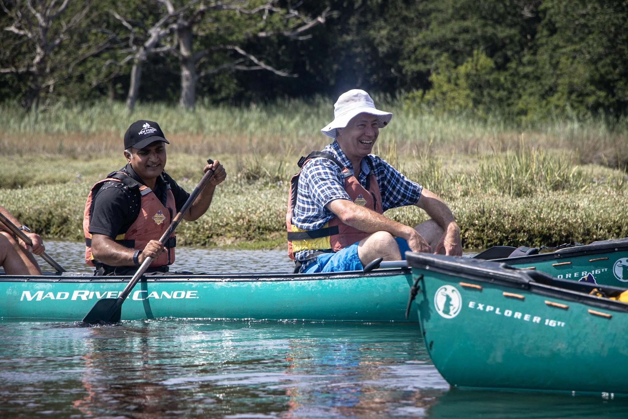 A group of men friends paddling to the pub after looking for fun activities for adults in The New Forest.