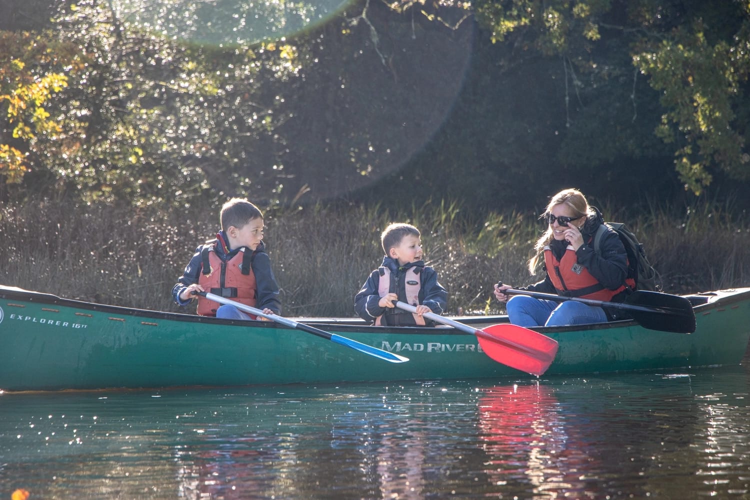 A family enjoying a Canoe Halloween Candy Hunt