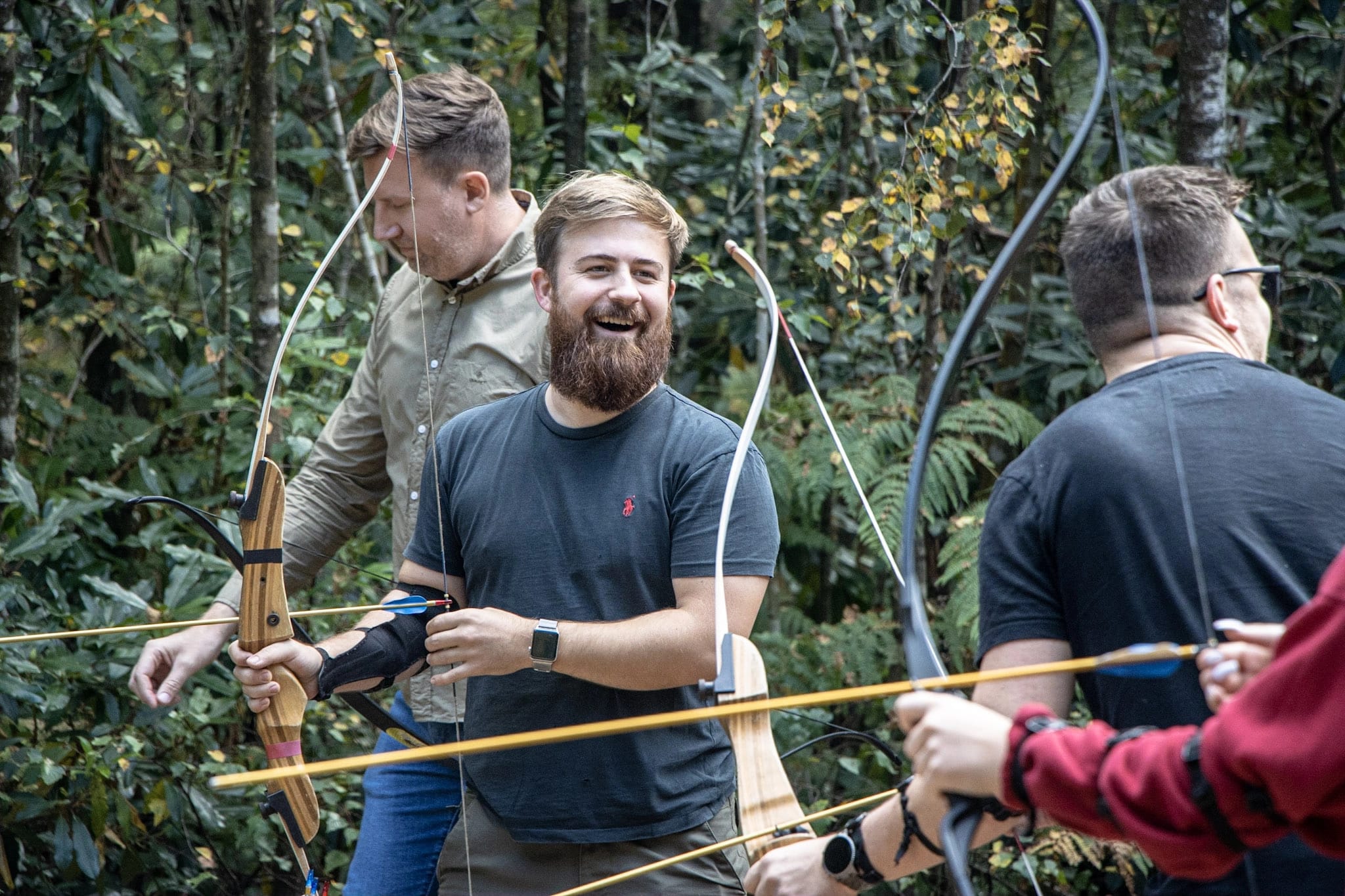 A team taking part in archery during their team development event