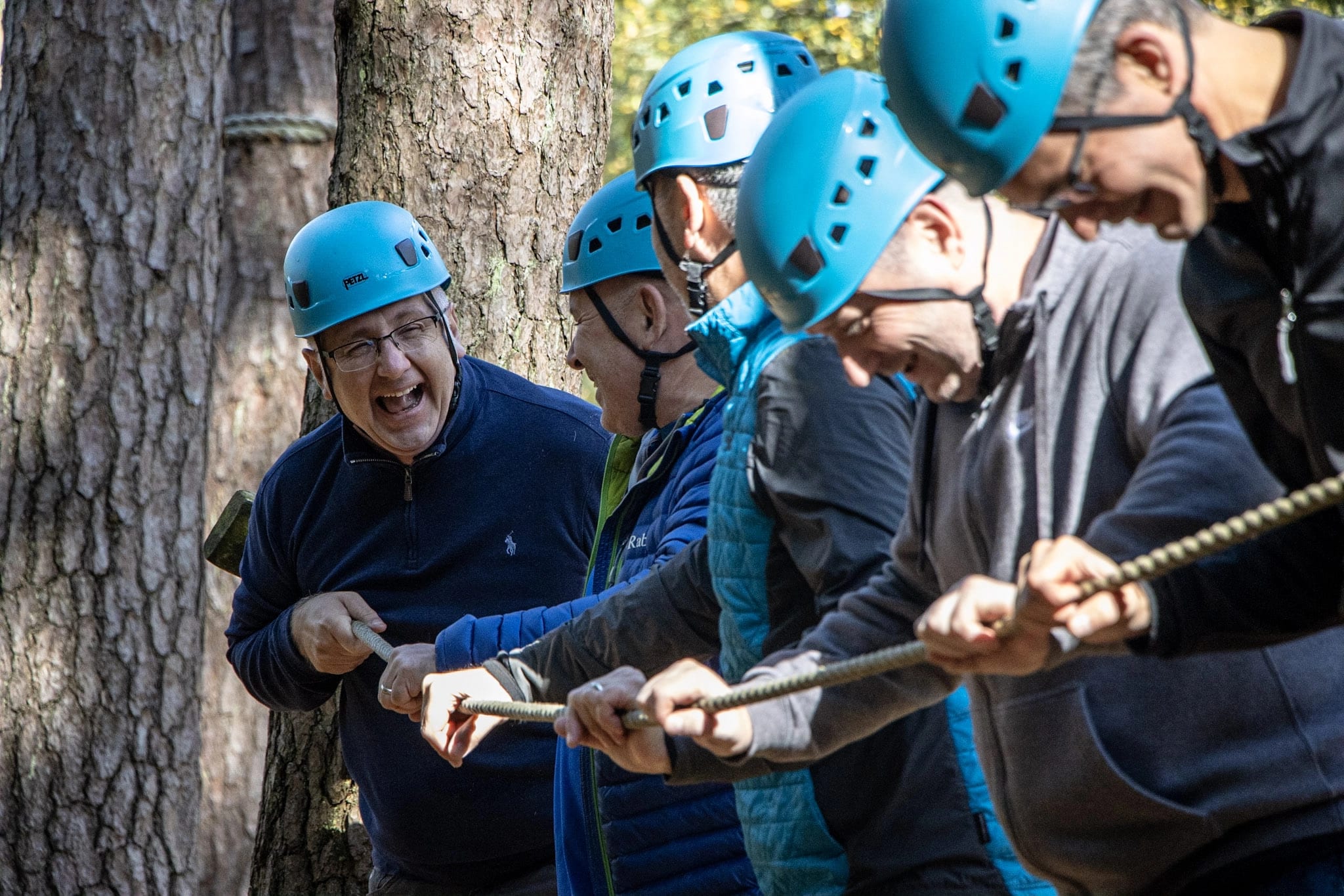 A team enjoying the low ropes as part of their team development event