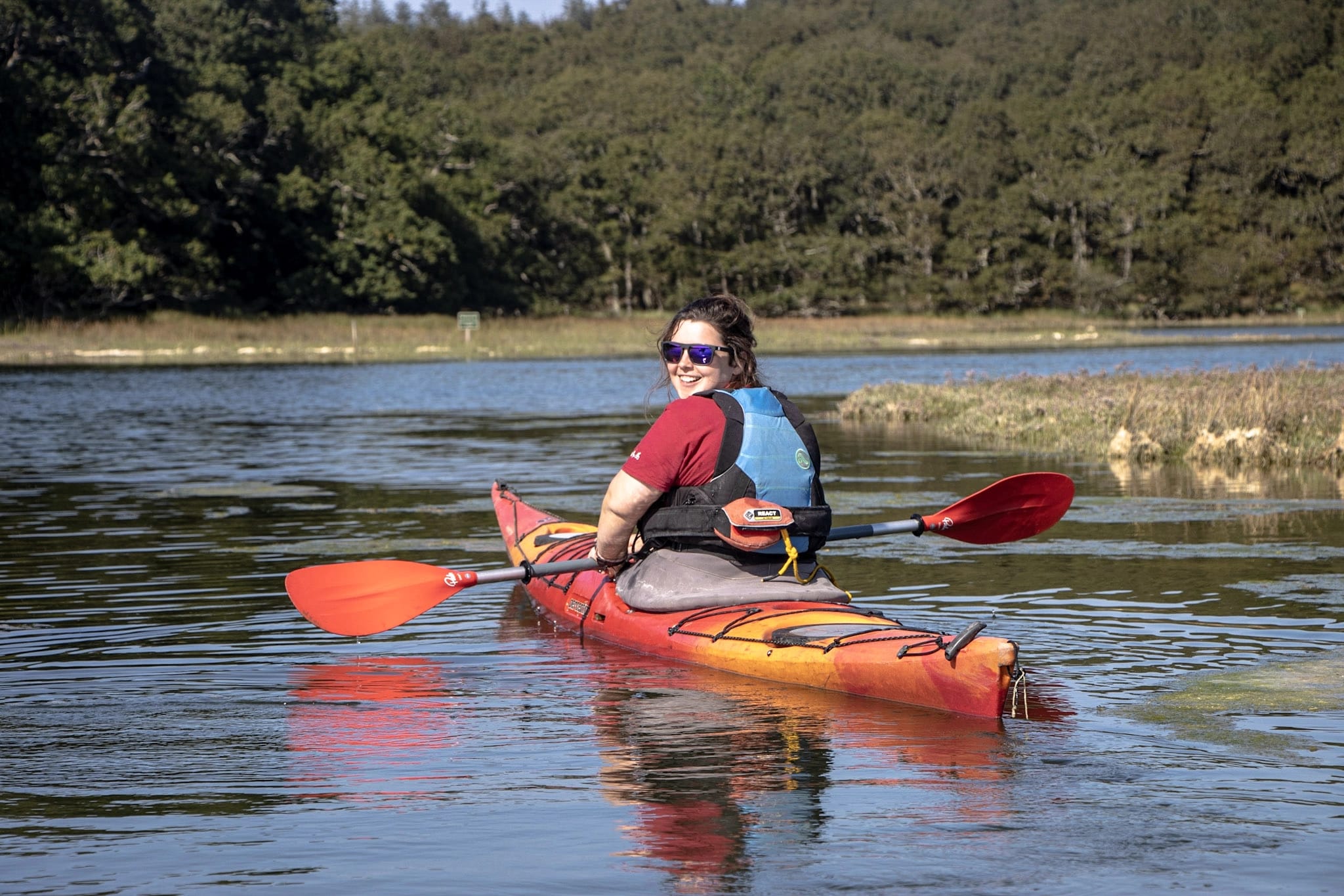 A lady learning to kayak and deliver kayaking sessions as part of an Outdoor Instructor Course