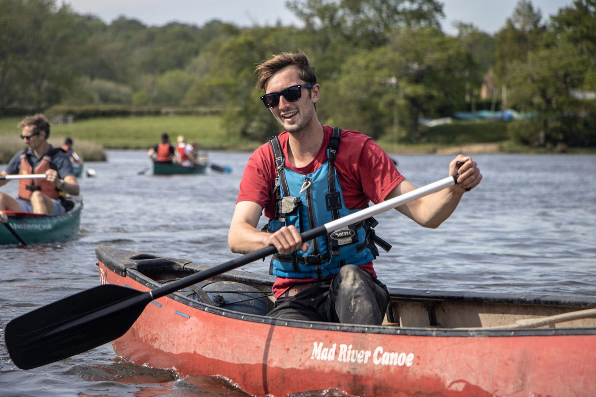 A an instructor delivering a canoeing session to a group of families