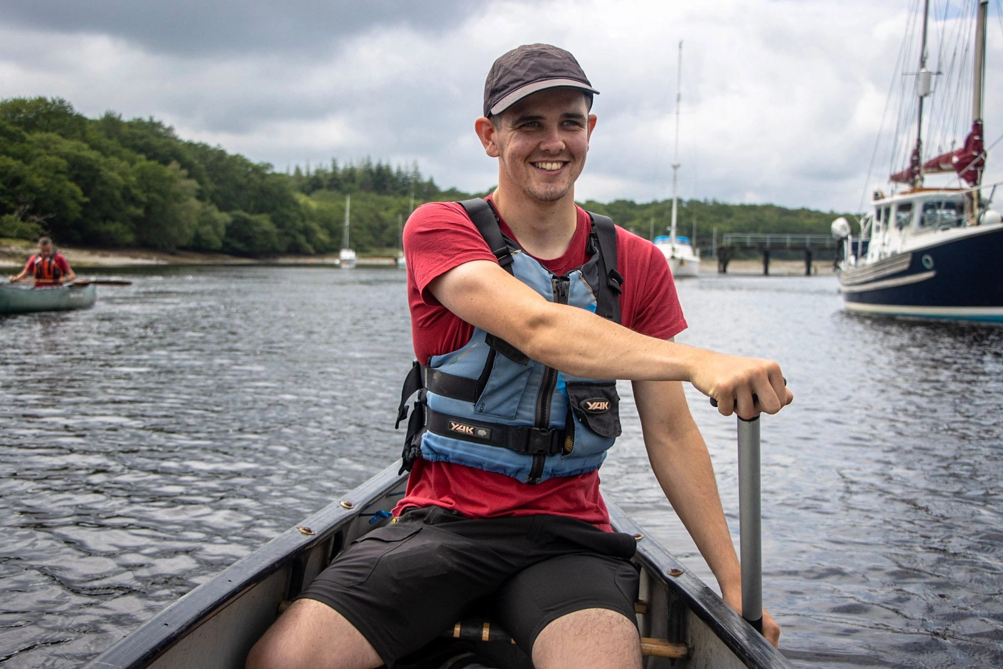 A an instructor delivering a canoeing session to a group of families