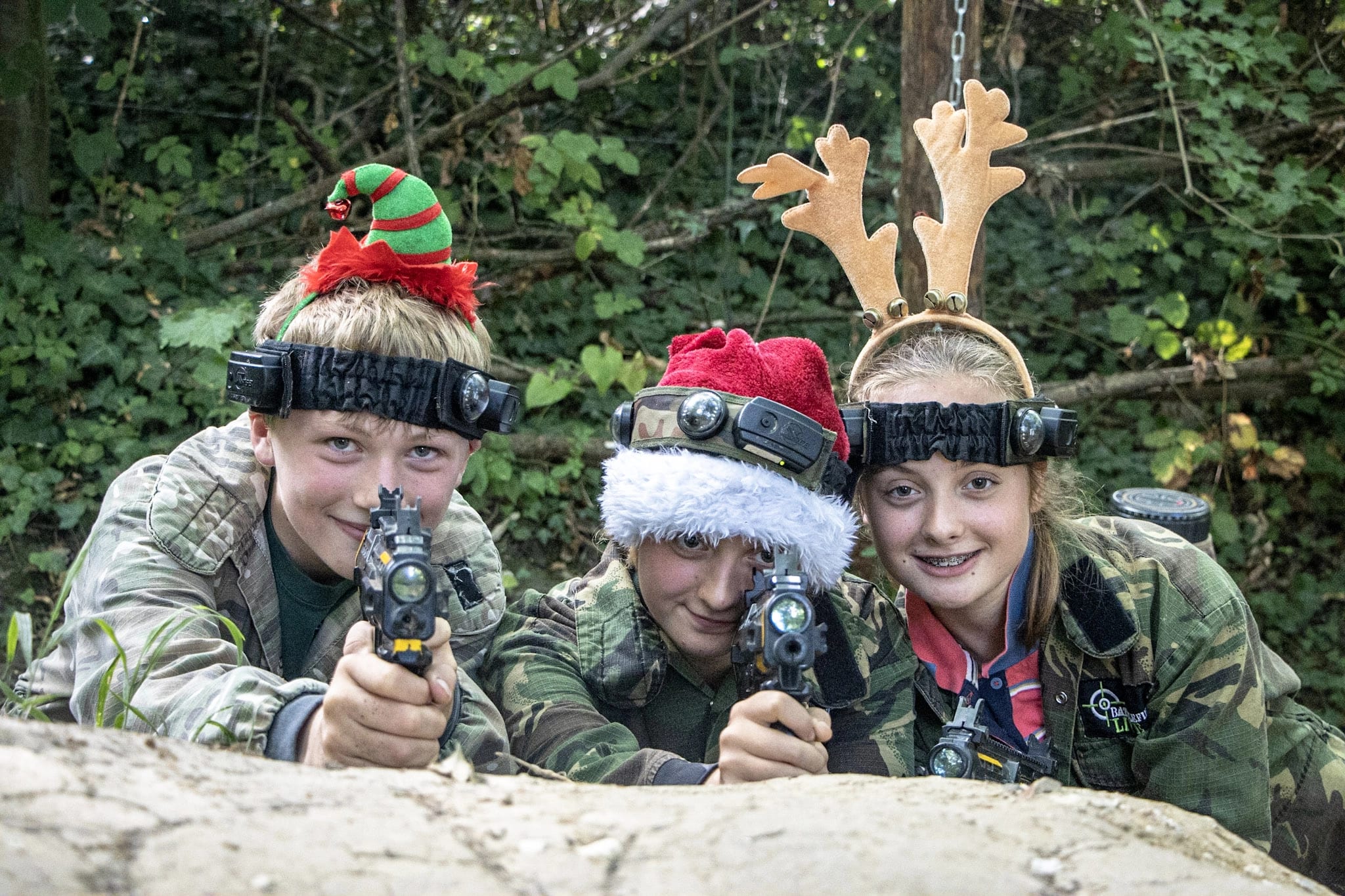 Three kids enjoying a festive BattleZone laser tag session!