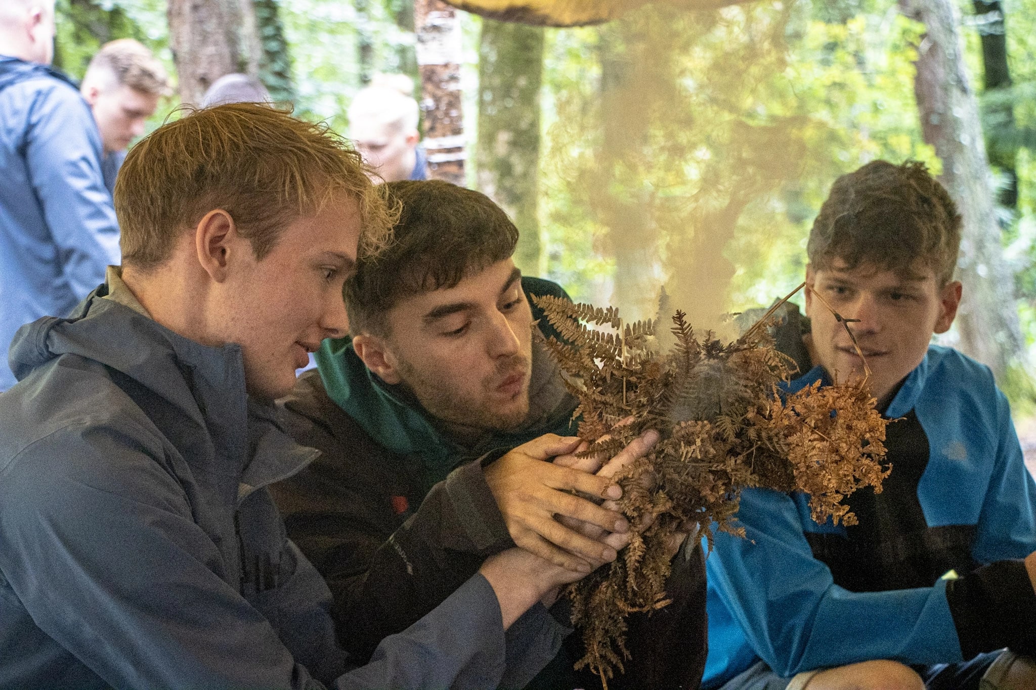 A group learning Bushcraft skills during a Woodland Adventure