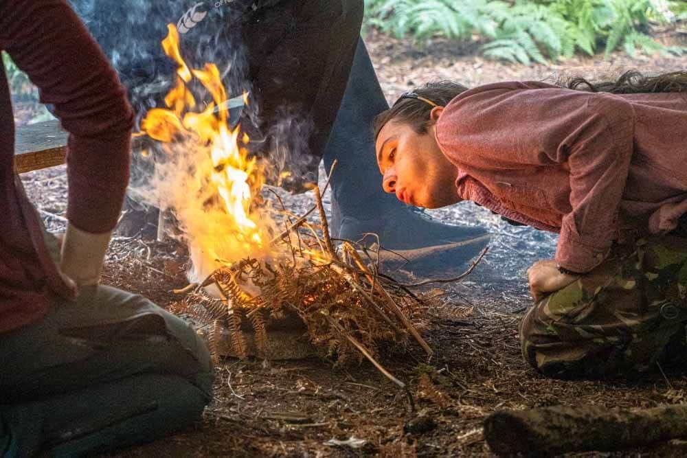 A man learning Bushcraft skills at New Forest Activities as part of a Team Growth Day